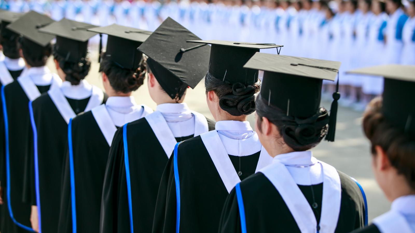 Line of graduates in caps and gowns