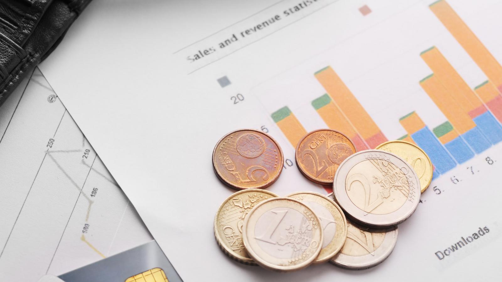 Paper with bar graphs and Euro coins