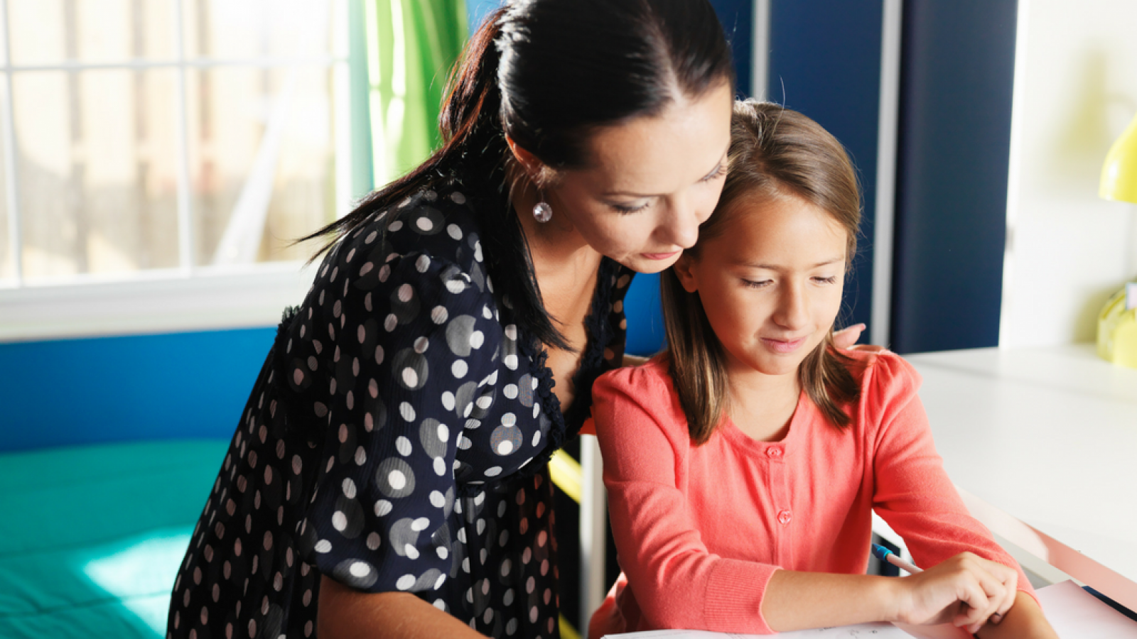 Child doing homework with guardian
