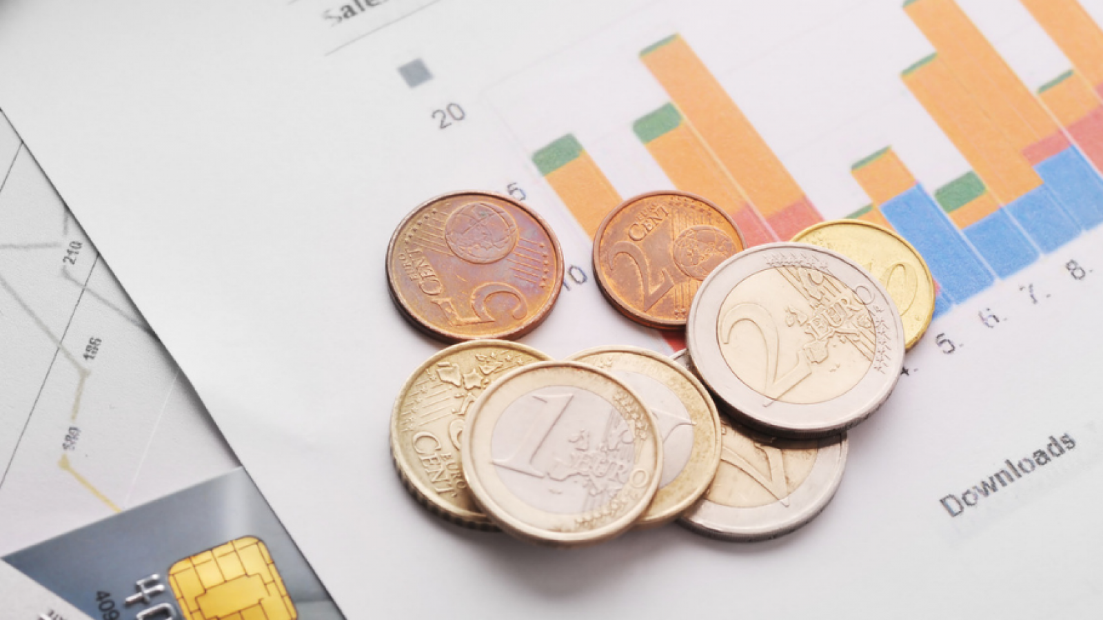 A couple of coins sit on a graph