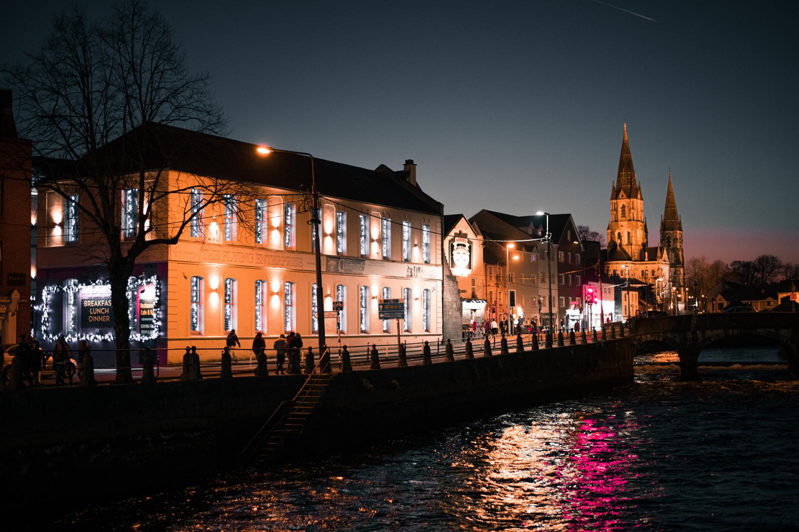 Houses alongside a river at night time
