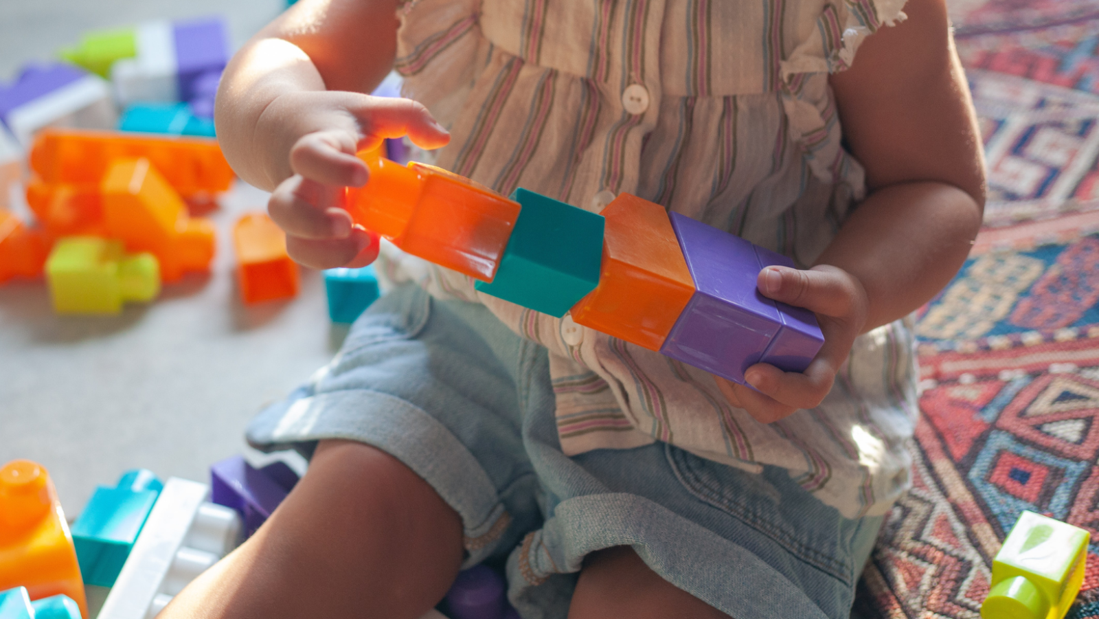 child playing with coloured blocks