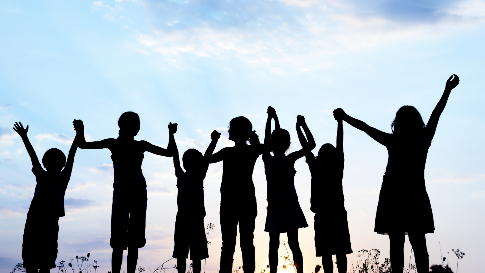 Children raising their hands, symbolising play and happiness