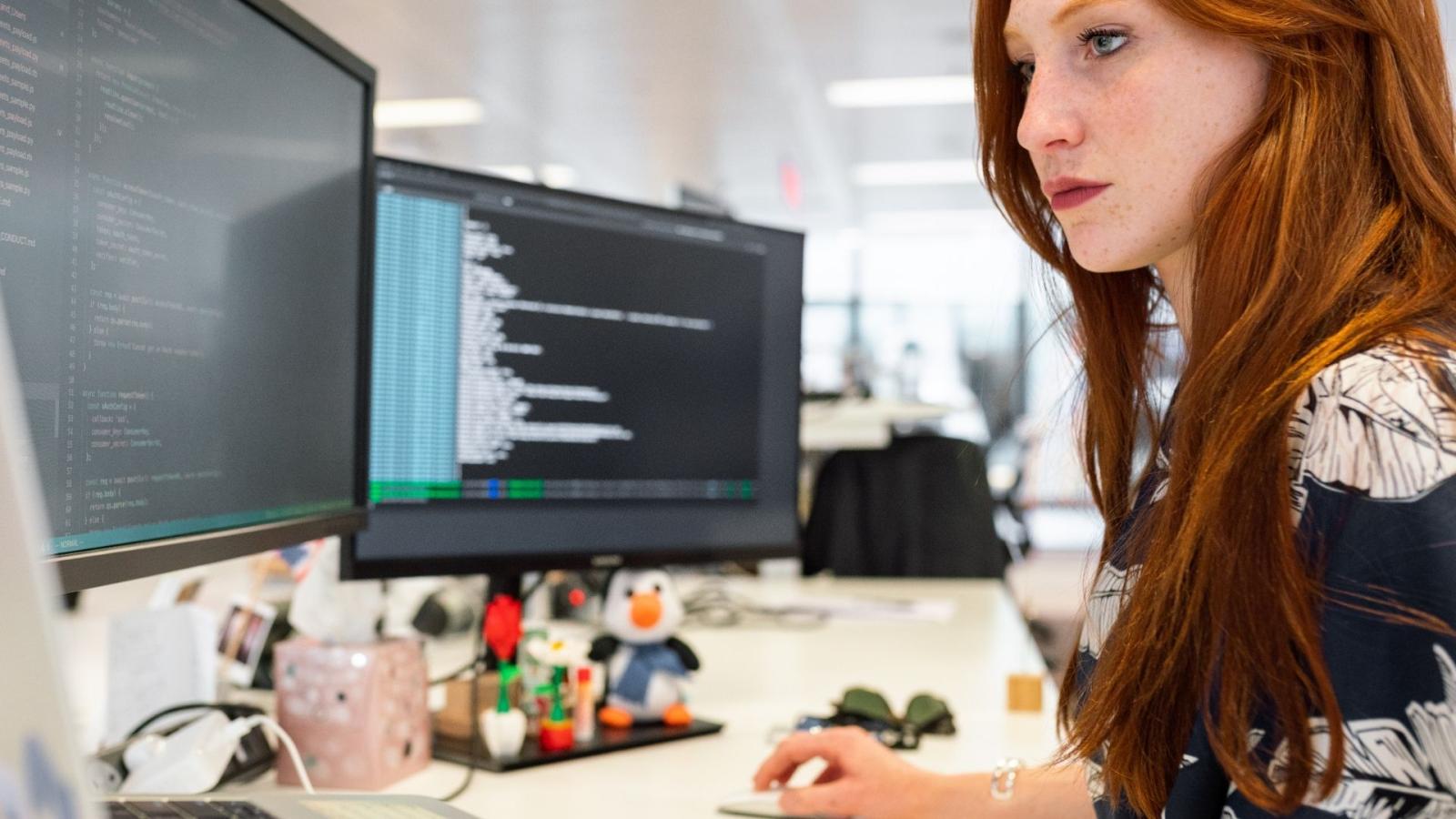 Woman coding at an office desk